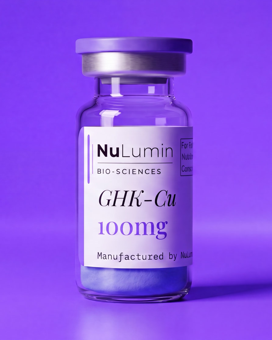 A sealed NuLumin vial standing upright, the freeze-dried cake settled in the base of the glass